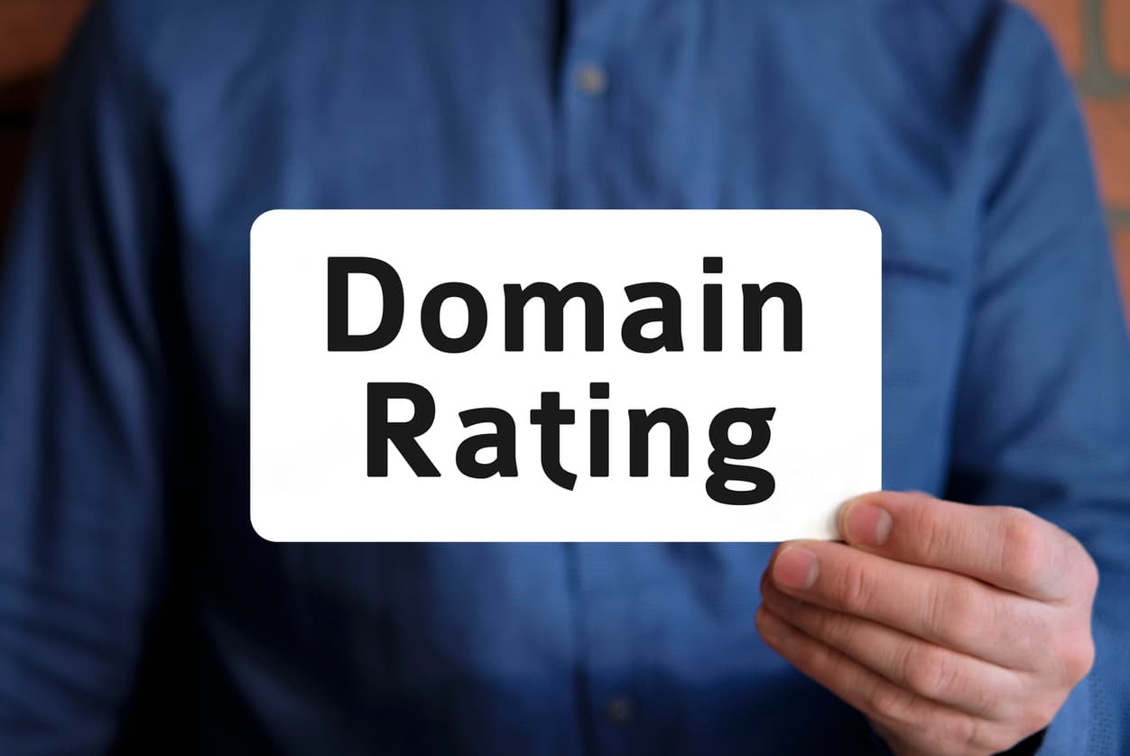 A man holding a sign which says domain rating