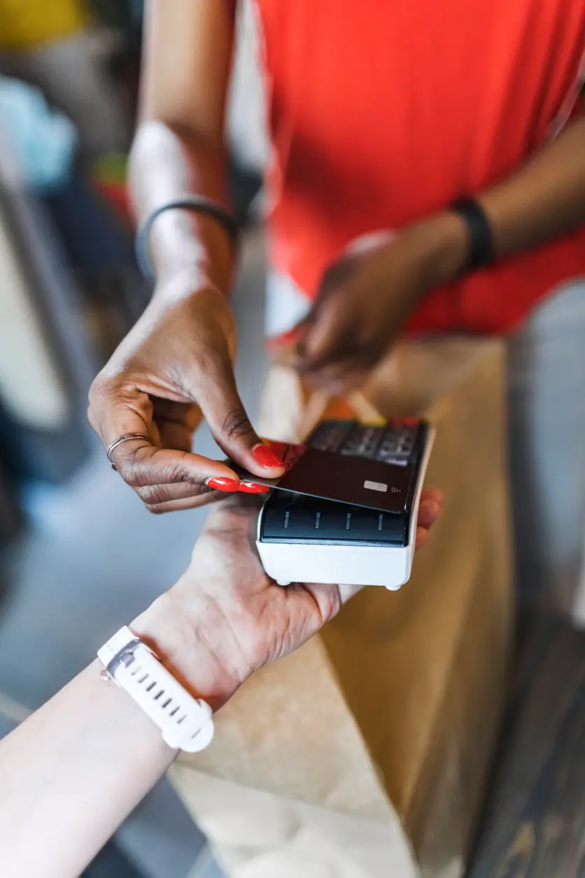 Lady making a purchase in a store using her credit card