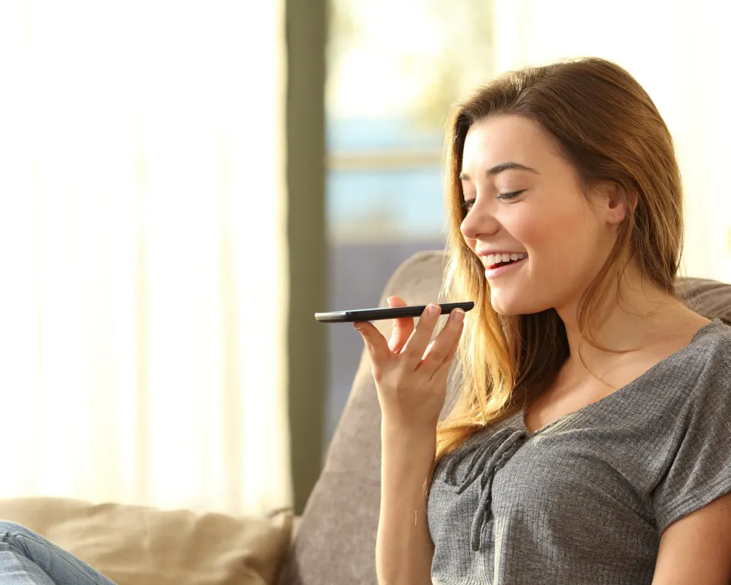 voice search SEO. A woman using voice search on mobile